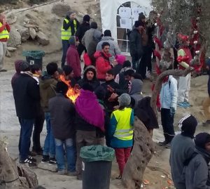 Volunteers with yellow vest and refugees in Lesvos, Greece