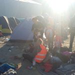Volunteer helping a syrian refugees family in Lesvos, Greece