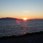 Sun appears on the Turkish coast in Lesvos, Greece